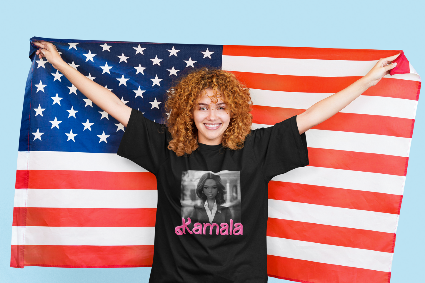 Smiling woman holding up an American flag who is wearing a black T-shirt.