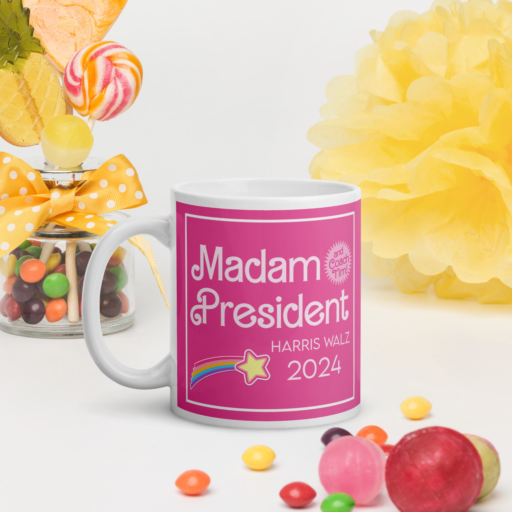 A glossy mug on a white surface surrounded by candy.