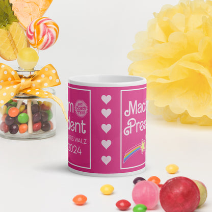 A side view of a glossy mug on a white surface surrounded by candy.