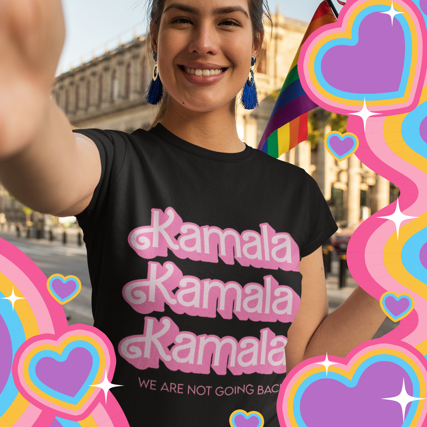 Woman taking a selfie and holding a rainbow flag who is wearing a black T-shirt.